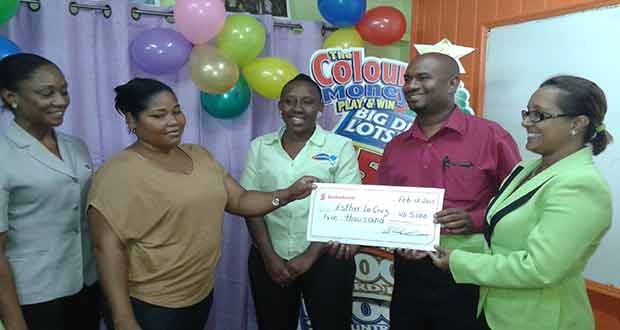 Ms Jennifer Cipriani and a representative from Harris Paints hand over the cheque worth US$5000 to Ms Esther La Cruz