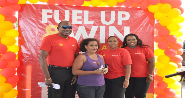 From Left: Sol Country Manager Orlando Boxill along with Kim Evelyn, cash cube money winner, Sol representative and Retail Sales Executive of Sol Guyana Inc., Renee Armstrong at the conclusion of the Christmas promotion Wednesday (Photo by Delano Williams)