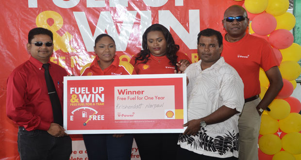 (Left) Sol Guyana Representatives pose with Krishendatt Narpaul along with Country Manager of Sol, Orlando Boxhill (right)