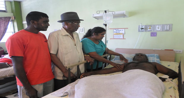 Bhopaul Nandkishore, aka Jai, lies on the hospital bed as he is visited by his son, Davo (left); father, Puna from Canada (centre); and wife, Sabo Nandkishore