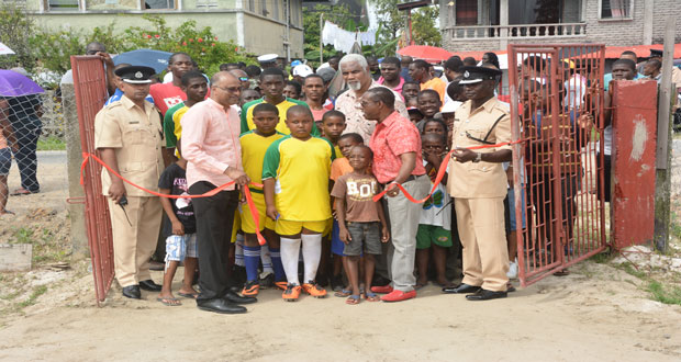Agricola residents look on as one of their youngsters assists with the traditional cutting of the ribbon to formally recommission the ground (Photo by Samuel Maughn)