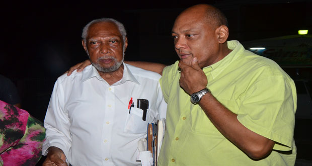 Raphael Trotman comforts his father, Donald Trotman, still shaken after the ordeal.