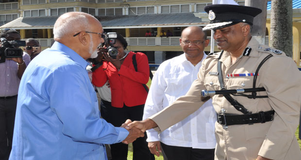 Commander-in-Chief- of Guyana’s Armed Forces President Donald Ramotar being greeted by Commissioner of Police Seelall Persaud.
