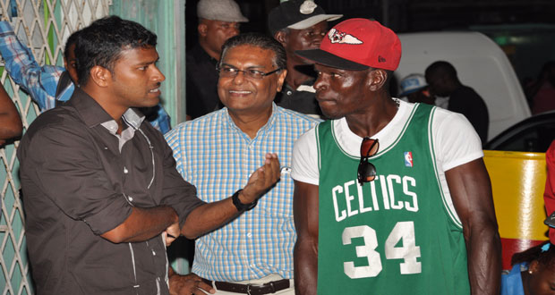 PPP/C’s Manzoor Nadir, centre, with ‘Six-Head Lewis’ and the Chronicle’s Tajeram Mohabir in Albouystown last evening