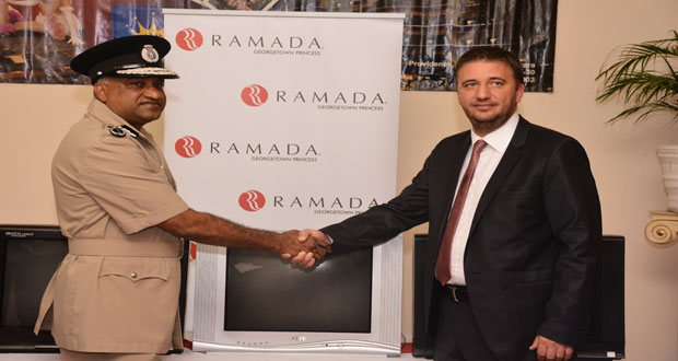 Top Cop Seelall Persaud shakes hands with Princess Hotel General Manager, Ugur Turetgen yesterday afternoon during the presentation ceremony at Princess Hotel (Photo by Samuel Maughn)