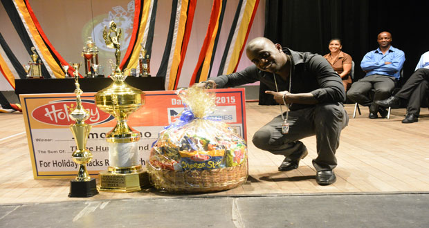 reigning Soca Monarch, Jumo Primo posing with his prizes.