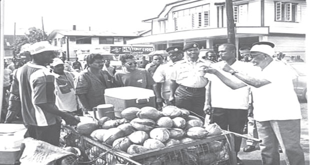 Dr Cheddi Jagan interacting with a roadside vendor in the late 1990s