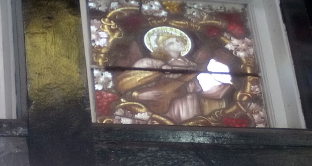 One of the damaged stained glass windows – the white spot shows where glass was broken.