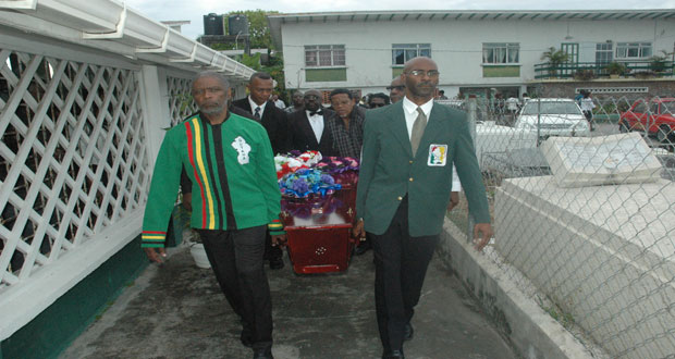 Pall bearers carry Shanomae to her final resting place yesterday. At left is GOA member Charles Corbin, followed by AAG president Aubrey Hutson and on the right is GOA member Garfield Wiltshire.