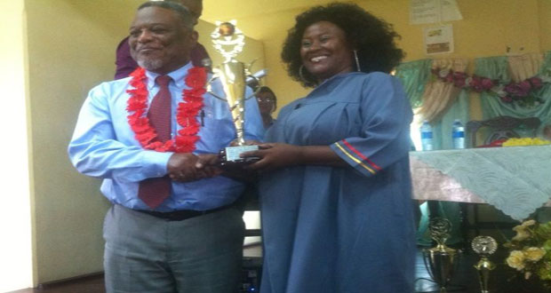 Prime Minister, Samuel Hinds presents Esther Jonas with the Best Graduating Student award