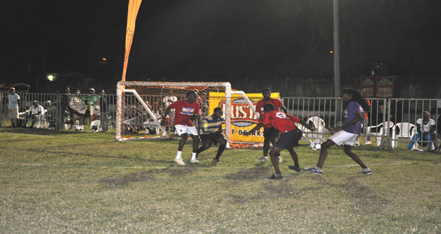 Even though there s a heavy presence of three defenders from North East LaPenitence (red top), this player from West Front Road ‘Gold is Money’ goes on the attack in search of a goal for his team, during last Friday night’s round of 16 action.