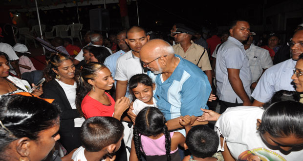 President Donald Ramotar is greeted by a young resident of Herstelling.