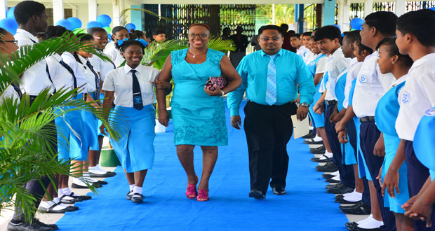 Ms. Gail Primo (centre) is accompanied down to the catwalk as she receives a captain’s welcome from the SJH population