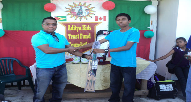 AKTFF director Premnauth Punwassie (left) hands over part of the gear to Andrew Persaud.