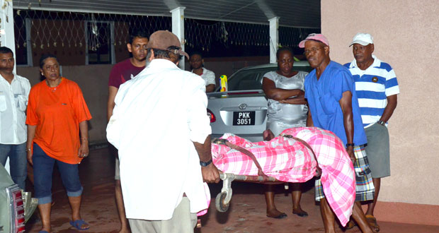 Undertakers removing the body of Ray Mangal from his home at  Buddy’s Housing Scheme, Providence last night