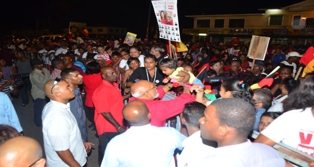 President Donald Ramotar hoists a youngster amid the carnival atmosphere at Lusignan last evening