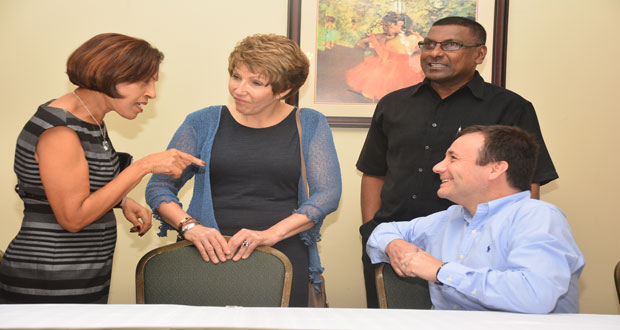 First Lady Deolatchmee Ramotar interacts with Dr Debra Isaac, Dr Rodrigo Soto and Dr Shamdeo Persaud.