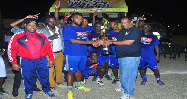 Champions! Guyana Beverage Company Managing Director Robert Selman presents the winners’ trophy to Sparta Boss captain following their 4-2 over West Front Road.