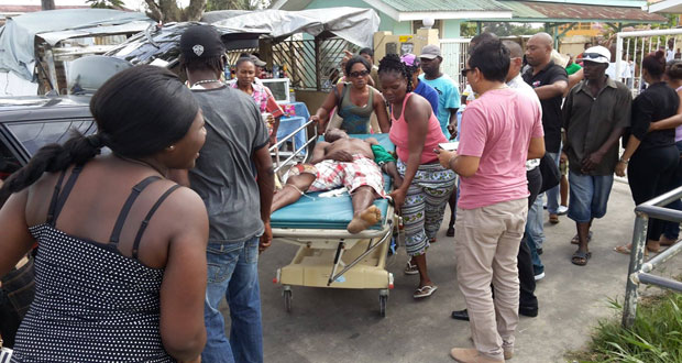 Family and friends wheel the body out of the Diamond Hospital Compound believing that he was still alive as they sought to transport him to the Georgetown Public Hospital.