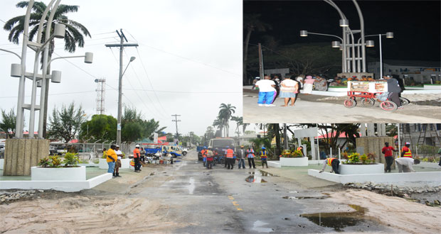 Workmen putting in the finishing touches around mid-afternoon yesterday in the restoration of the National Independence Arch on upper Brickdam and Vlissengen Road, venue of one of three events slated for tomorrow’s Independence Anniversary celebrations. Inset is the scene at the ‘Arch’ last night at around 22:20 hrs (Photos by Samuel Maughn and Delano Williams)