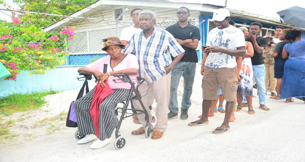 Another elderly woman waiting patiently to cast her ballot.