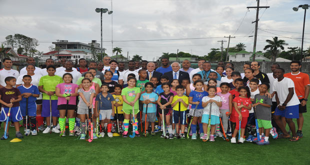 International Hockey Federation (FIH) president Leandro Negre (with black suit and blue tie) strikes a pose with young local hockey players at the GCC ground yesterday. At Negre’s right is Pan American Hockey Federation president Alberto `Coco’ Budeisky).