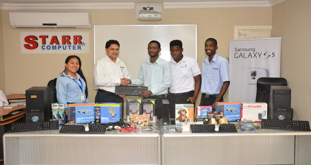 Starr Computer General Manager, Rehman Majeed hands over IT equipment to GTI’s Revon Thorman (Photo by Samuel Maughn)