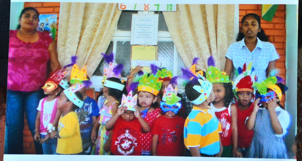 Principal Surasattie Walker (left) and children of Precious Gems Playschool during a school party.  At right is Teacher Sharda