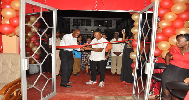Brothers Eworth Williams and Ryan Rajmangal cutting the ceremonial ribbon to officially open the restaurant