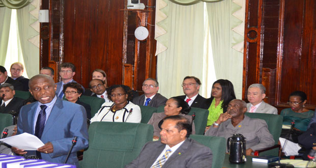 Foreign Affairs Minister Carl Greenidge updating the House this past week. Venezuelan Ambassador to Guyana, Reina Diaz, is seated at far right in photograph