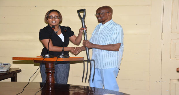 Scotiabank Guyana Marketing Manager, Jennifer Cipriani, hands over one of the tools to Mayor Green.