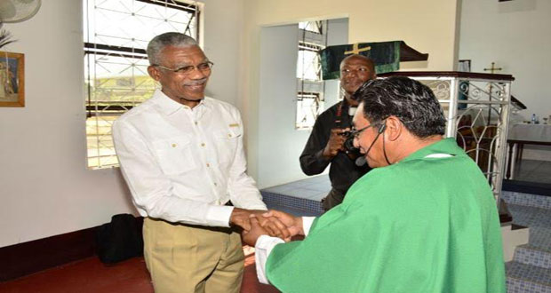 President David Granger being greeted by Reverend Alfred David upon his arrival at the St. John the Baptist Church