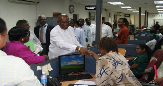 Minister of Finance, Winston Jordan greeting staff of the GRA’s Human Resources Division during a recent visit
