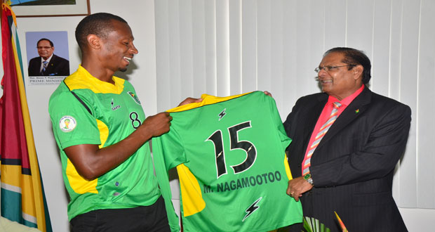 Captain of the Guyana Golden Jaguars, Christopher Nurse, presents Prime Minister Moses Nagamootoo with an official player’s jersey