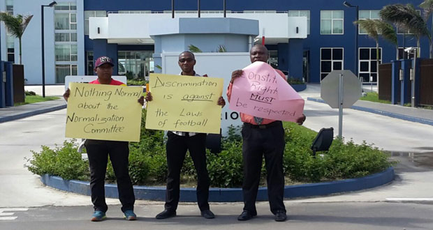 (L-R) Otis James, Collis Gift and Christopher Matthias protest outside of the Marriott Hotel yesterday.