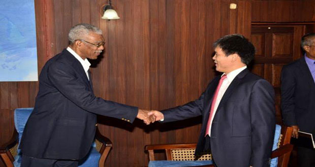 President David Granger exchanging a handshake with General Manager of China Harbour Engineering Company Ltd., Xiaofeng Wang, at the presidential complex in Georgetown yesterday