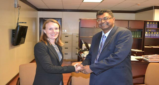 Second Vice President and Minister of Public Security, Mr. Khemraj Ramjattan greeting outgoing Canadian High Commissioner to Guyana, Dr. Nicole Giles, during a courtesy call