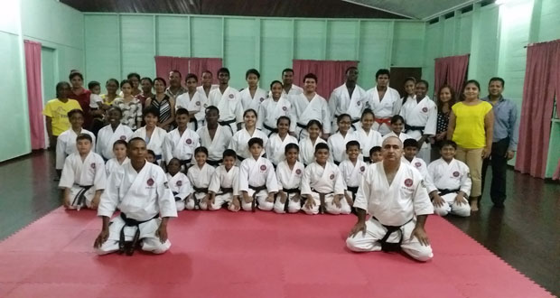 Sensei Jeffrey Wong poses with his students in the presence of their parents.