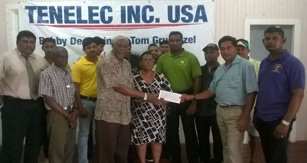 Bobby Deonarine of Tenelec Inc, Washington presents sponsorship cheque to Gurvy Harry and Angela Haniff in the presence of other representatives of the sponsor, officials of BCB, representative of Regional Administration and cricketers who have participated in these competitions over the years.