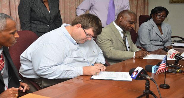 U.S. Embassy Charge d’Affaires, Bryan Hunt and Foreign Minister Carl Greenidge sign the amended Letter of Agreement for the CBSI