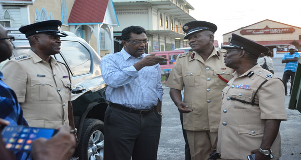 Public Security Minister, Khemraj Ramjattan speaks to ‘A’ Division Commander, Clifton Hicken in the presence of Fire Chief, Marlon Gentle and Deputy Superintendent of Police, Anthony Vanderhyden at the scene of the Tiger Bay fire