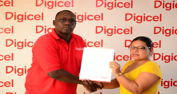 Digicel Guyana Events and Sponsorship Manager, Gavin Hope, as he hands over a cheque to chairperson of the Moruca Expo Committee, Ingrid Harris, at the company’s headquarters at Fort and Barrack Streets, Kingston