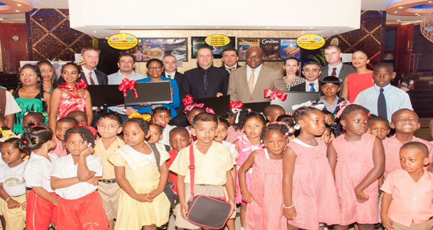 Management officials of Princess Guyana, along with Tourism Minister Cathy Hughes and Chief Education Officer Olato Sam, pictured with some of the children whose schools were awarded by Fun City Entertainment Centre (Delano Williams photo)