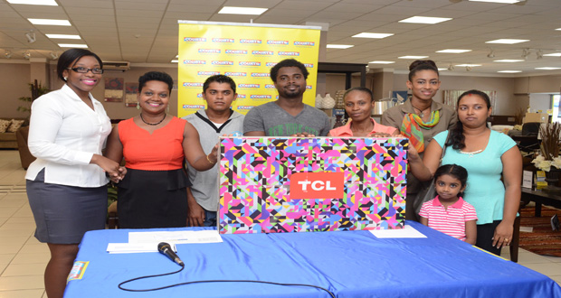 Courts’s Roberta Ferguson with some of the 10 winners of the Courts TCL smart tv promotion, in which winners received one year free Netflix subscriptions (Photos by Delano Williams)