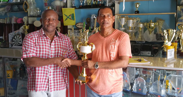 Trophy Stall Manager Ramesh Sunich hands over trophy to Fitness Paradise Manager Donald Sinclair