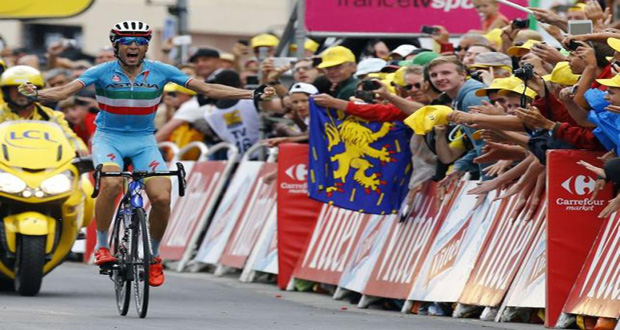 Astana rider Vincenzo Nibali of Italy celebrates as he crosses the finish line to win the 138-km (85.74 miles) 19th stage of the 102nd Tour de France cycling race.