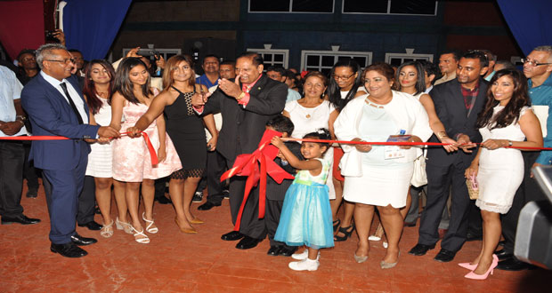 Acting President and Prime Minister,  Mr. Moses Nagamootoo cuts the ceremonial ribbon to officially open the Giftland Mall at Turkeyen, East Coast Demerara. Amomng those cheering him on are President of Giftland Mall, Mr. Roy Beepat (left); Minister of Business, Mr. Dominic Gaskin (right); and members of the Beepat family (Photo by Delano Williams)