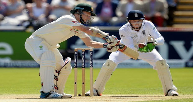 Chris Rogers goes on the attack while wicketkeeper Jos Buttler looks on.