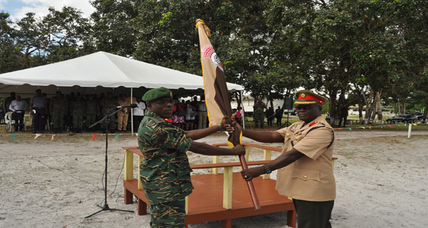 Outgoing Commander Colonel Enoch Gaskin hands over the Battalion’s Colours to its new Commander, Colonel Patrick West