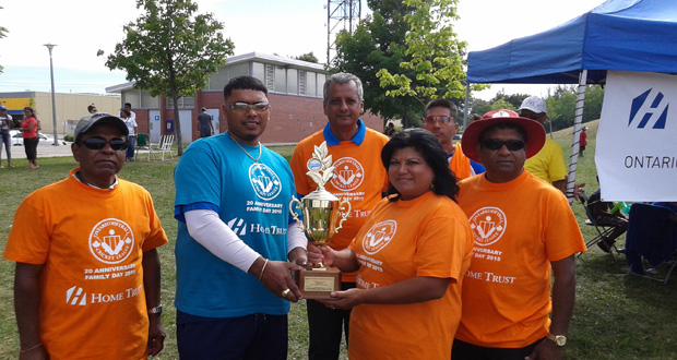 JAGUARS skipper Kumar Doodnauth collects the winning trophy from OSCL treasurer Kim Sue in the presence of other executives.